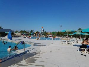 two pools with many people swimming