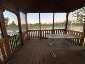 interior cabin patio deck with lakeside view and picnic table